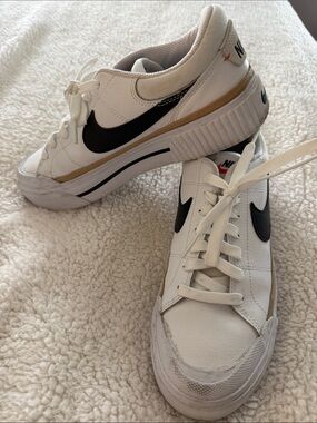 Nike Women’s White Sneakers with Black Swoosh and Gold Trim